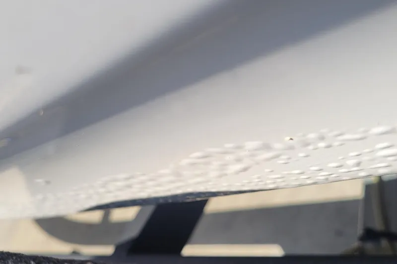 Slide: The Image of Close-up of 2024 Tahoe T21 boat hull with water droplets. - 10