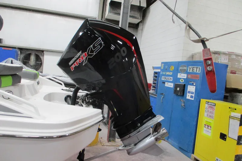 Slide: The Image of 2024 Tahoe T21 boat with Mercury Pro XS 200 engine in a workshop setting. - 16