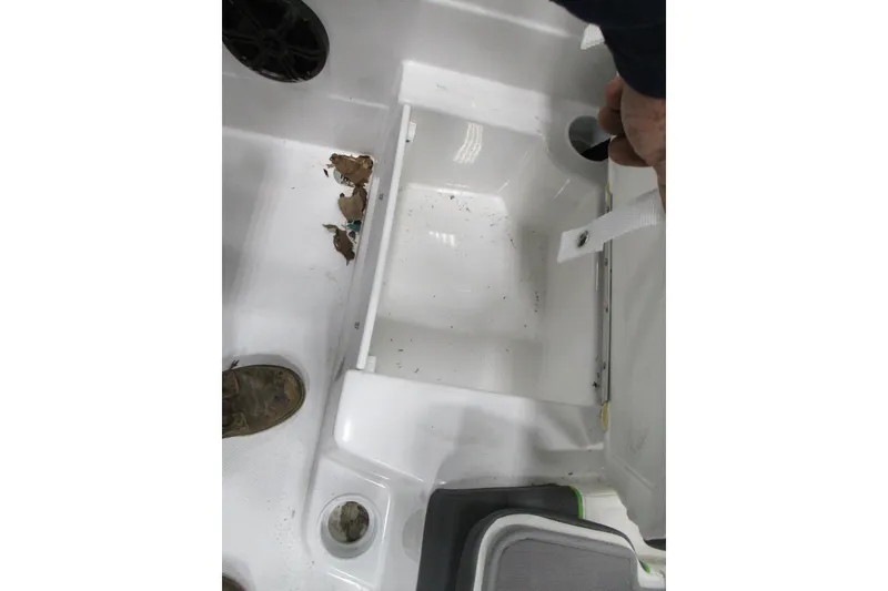 Slide: The Image of 2024 Tahoe T21 boat interior with storage compartment and speaker. - 2