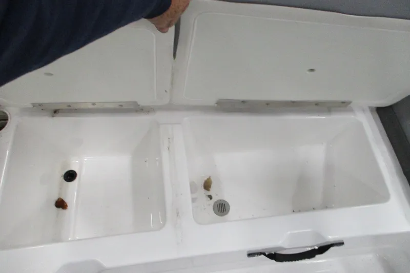 Slide: The Image of Open storage compartments in a 2024 Tahoe T21 boat, showing interior details. - 20