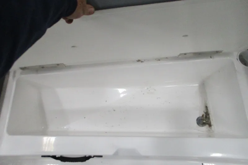 Slide: The Image of Open storage compartment in 2024 Tahoe T21 boat, showing interior details. - 21