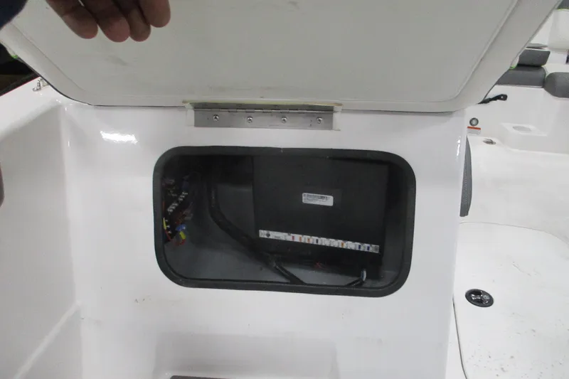 Slide: The Image of 2024 Tahoe T21 boat compartment with wiring and fuse box visible. - 22