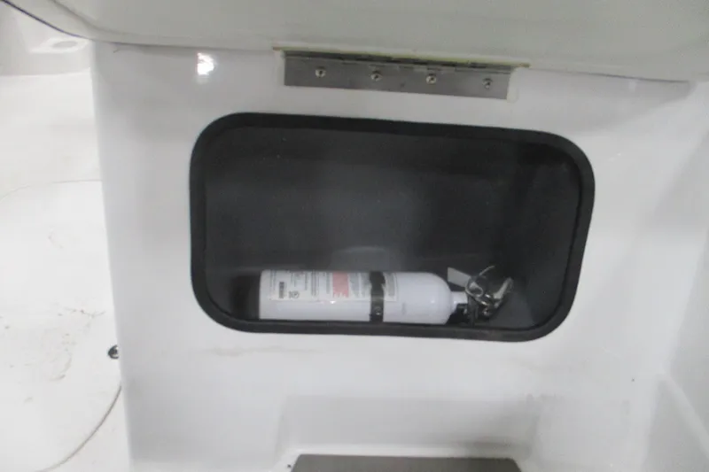 Slide: The Image of 2024 Tahoe T21 storage compartment with a fire extinguisher inside. - 23