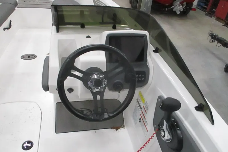Slide: The Image of 2024 Tahoe T21 boat dashboard with steering wheel and control panel. - 24