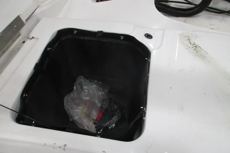 Slide: The Image of Open storage compartment in 2024 Tahoe T21 boat with plastic bag inside. - 6