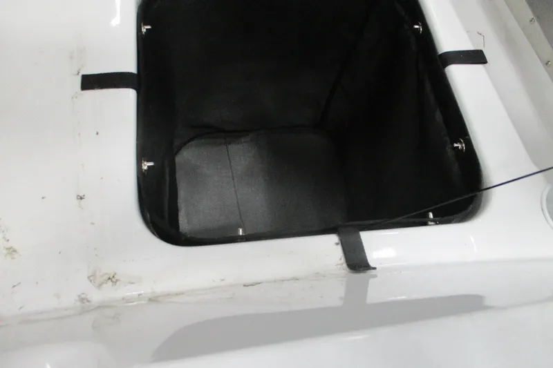 Slide: The Image of 2024 Tahoe T21 boat storage compartment with black interior and white exterior. - 8