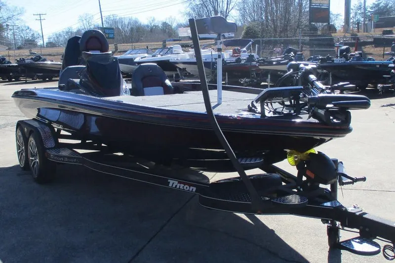 Slide: The Image of 2026 Triton 20XP Patriot boat on trailer in outdoor showroom. - 10