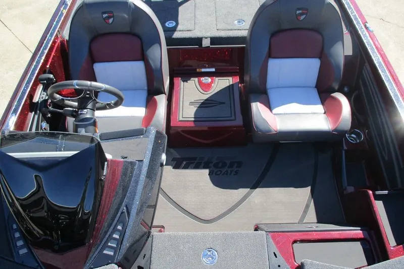 Slide: The Image of 2026 Triton 20XP Patriot boat interior with dual seats and steering wheel. - 11