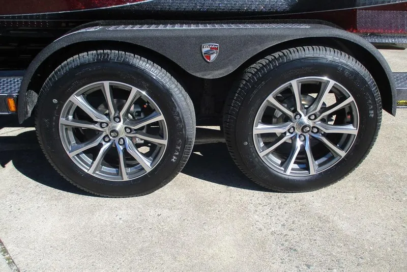 Slide: The Image of 2026 Triton 20XP Patriot trailer with dual alloy wheels on concrete surface. - 12