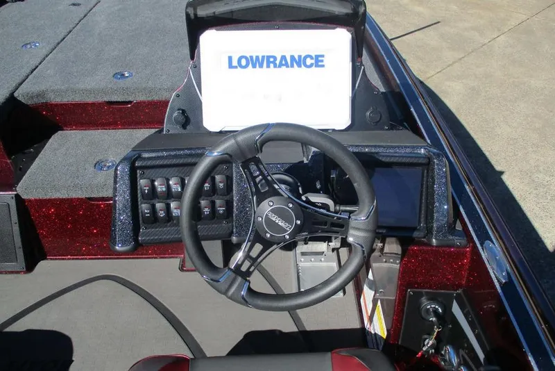 Slide: The Image of 2026 Triton 20XP Patriot boat dashboard with Lowrance display and steering wheel. - 5