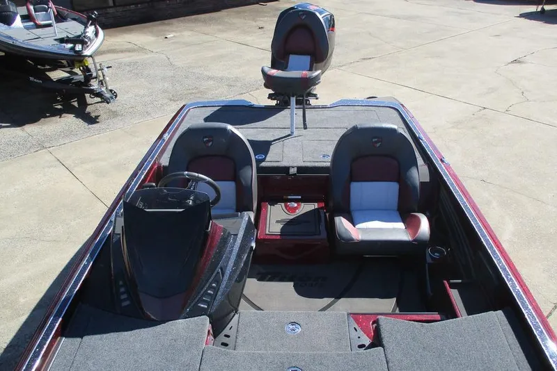 Slide: The Image of 2026 Triton 20XP Patriot boat interior with seating and steering console. - 6