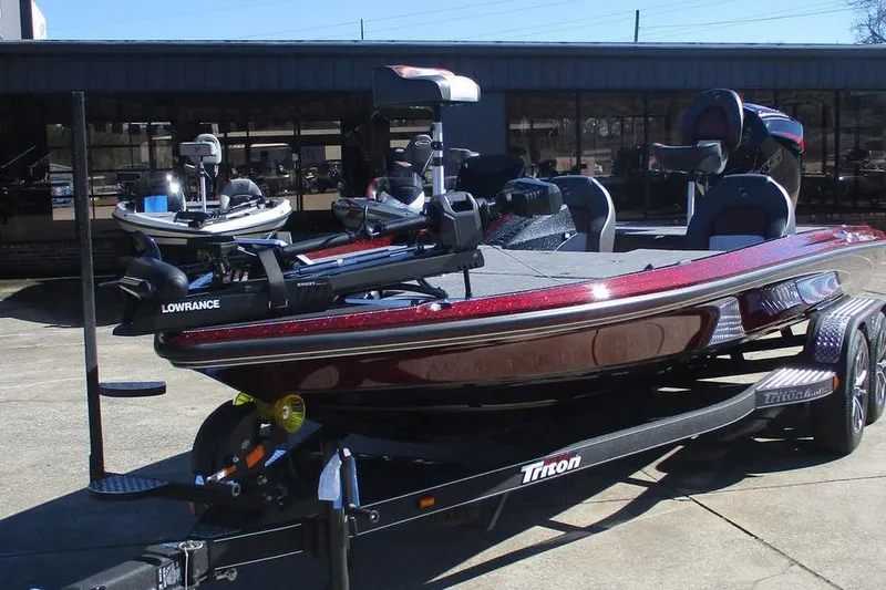 Slide: The Image of 2026 Triton 20XP Patriot boat on trailer, featuring Lowrance equipment. - 9
