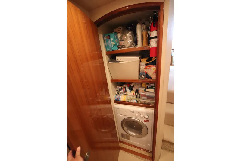 Slide: The Image of Laundry area with storage shelves in 2011 Viking 46 Convertible yacht. - 12