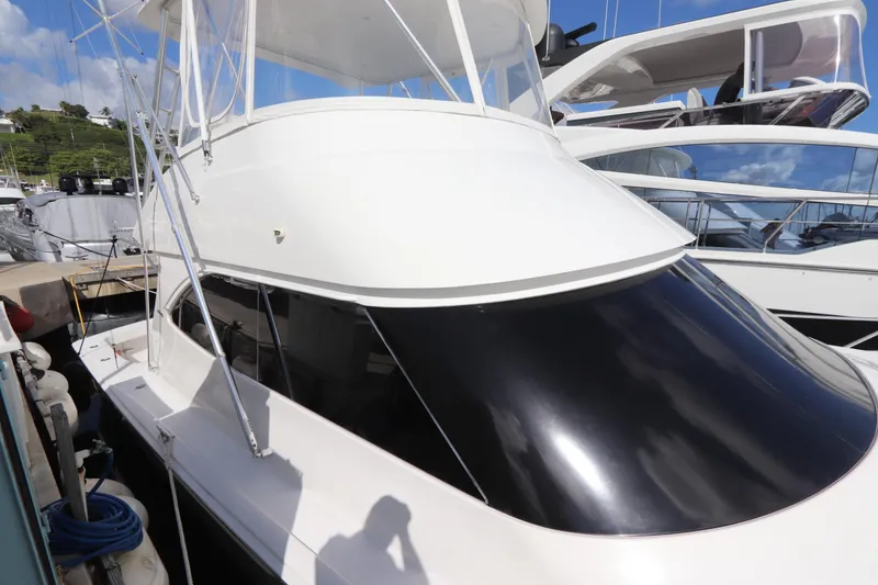 Slide: The Image of 2011 Viking 46 Convertible yacht docked at marina under clear blue sky. - 13