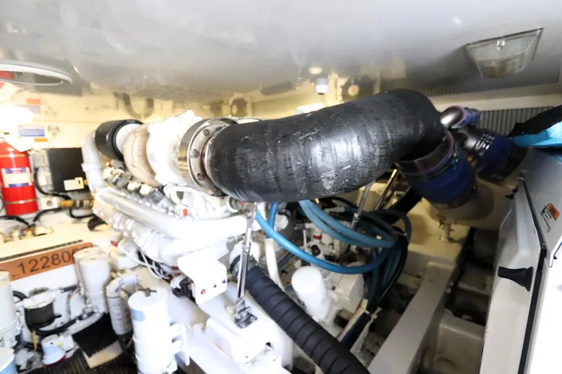 Slide: The Image of Engine room of 2011 Viking 46 Convertible yacht, showcasing complex machinery and components. - 16