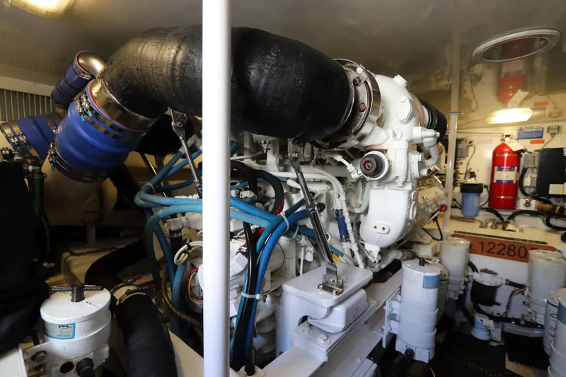 Slide: The Image of Engine room of 2011 Viking 46 Convertible yacht, showcasing complex machinery and components. - 17