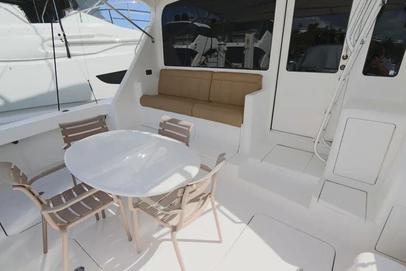 Slide: The Image of 2011 Viking 46 Convertible yacht deck with seating and table. - 24