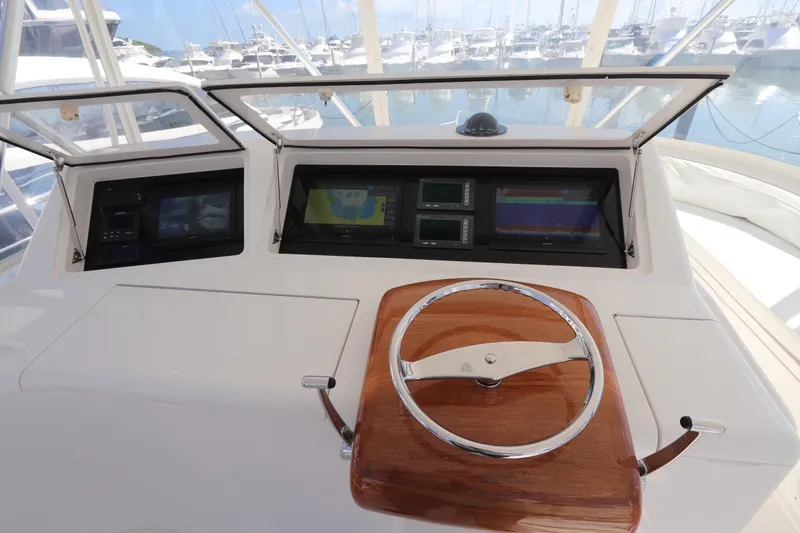 Slide: The Image of 2011 Viking 46 Convertible yacht helm with navigation displays and wooden steering wheel. - 25