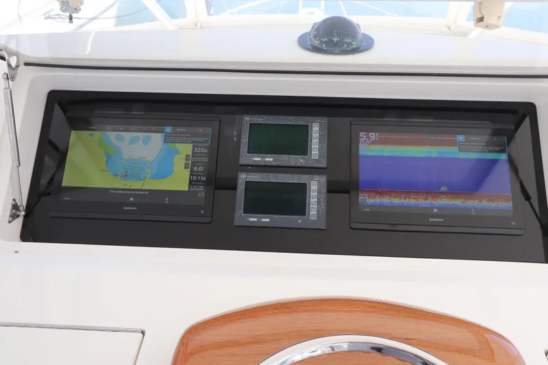Slide: The Image of Viking 46 Convertible 2011 dashboard with Garmin navigation displays and compass. - 26
