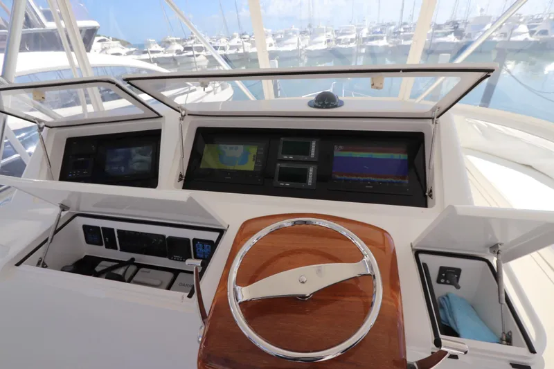 Slide: The Image of 2011 Viking 46 Convertible yacht helm with navigation displays and wooden steering wheel. - 28