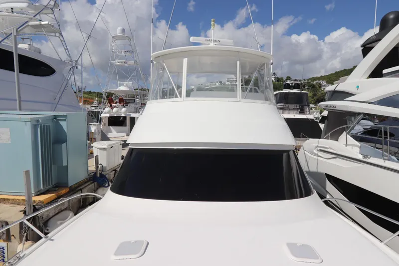 Slide: The Image of 2011 Viking 46 Convertible yacht docked at marina under blue sky. - 34