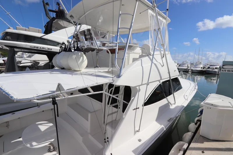 Slide: The Image of 2011 Viking 46 Convertible yacht docked at marina under clear blue sky. - 35