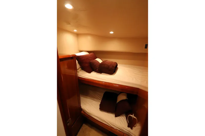Slide: The Image of Cozy cabin interior of 2011 Viking 46 Convertible yacht with bunk beds and soft lighting. - 8