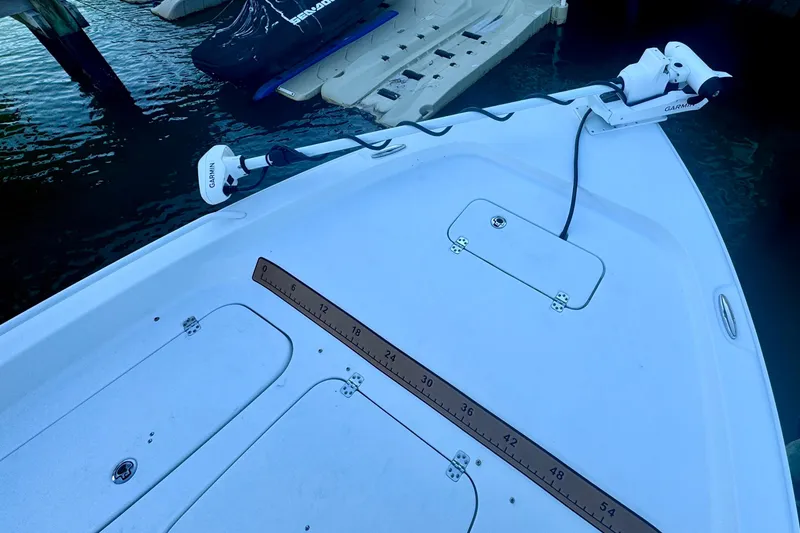 Slide: The Image of 2024 Sea Hunt BX 25 FS boat deck with Garmin equipment, docked near water. - 17