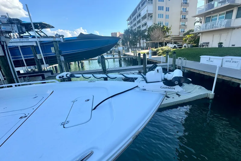 Slide: The Image of 2024 Sea Hunt BX 25 FS boat docked near waterfront buildings and Garmin equipment. - 18
