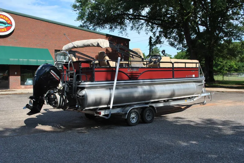 Slide: The Image of 2019 Lowe SF 232 Sport Fish pontoon boat on trailer, parked outside a building. - 5
