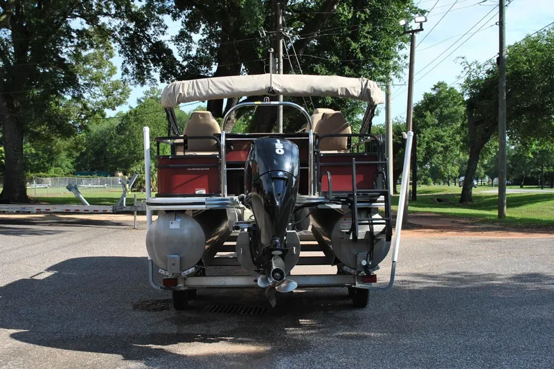 Slide: The Image of 2019 Lowe SF 232 Sport Fish pontoon boat with outboard motor, parked on a sunny day. - 6
