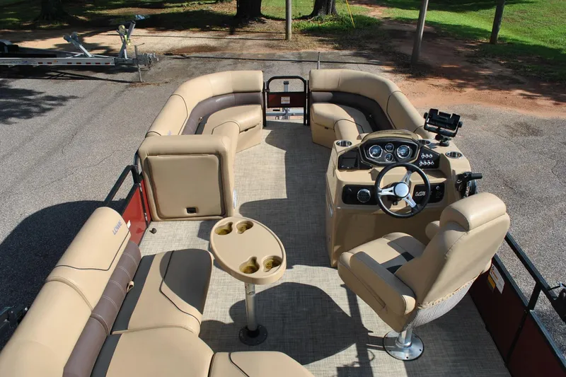 Slide: The Image of 2019 Lowe SF 232 Sport Fish pontoon boat with beige seating and steering console. - 7