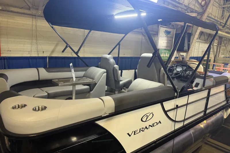 Slide: The Image of 2026 Veranda Relax VR22RC pontoon boat with canopy and seating, displayed indoors. - 11