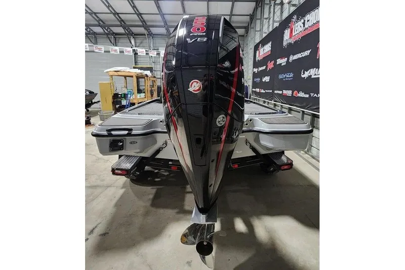 Slide: The Image of 2026 Triton 21XP Patriot boat with powerful V8 engine in a showroom. - 3