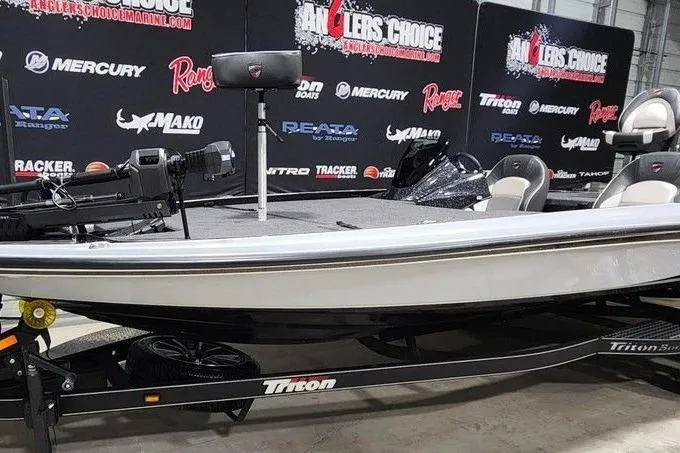 Slide: The Image of 2026 Triton 21XP Patriot boat displayed at Anglers Choice event with branded backdrop. - 4