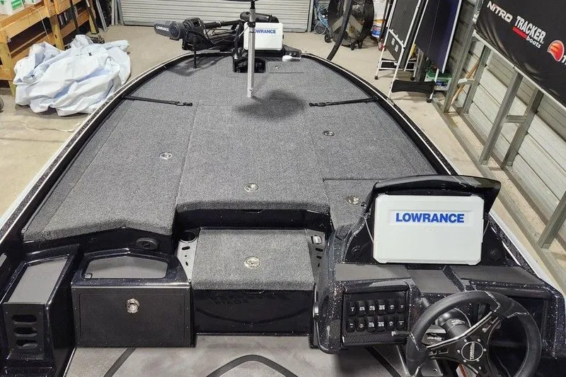 Slide: The Image of 2026 Triton 21XP Patriot boat interior with Lowrance electronics and spacious deck. - 9