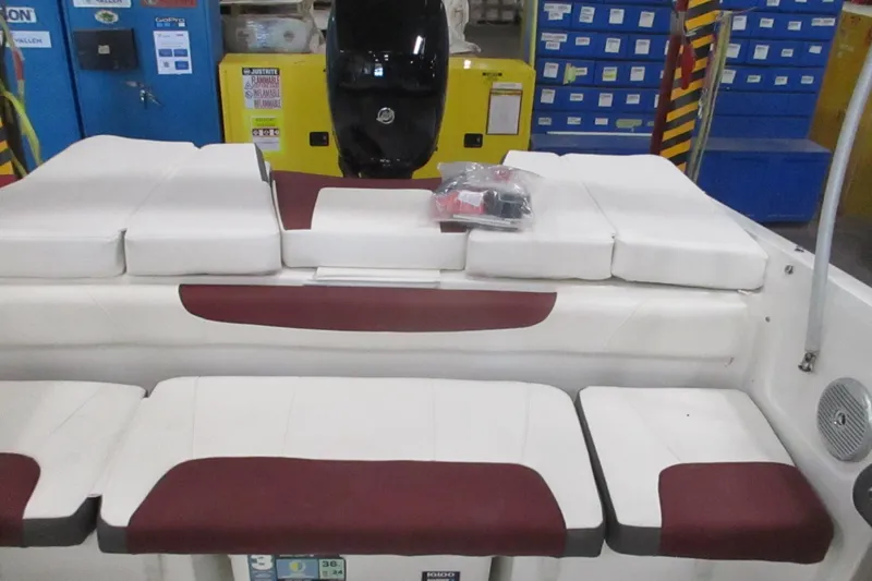 Slide: The Image of 2024 Tahoe 200 S boat interior with white and maroon seating, storage compartments. - 13