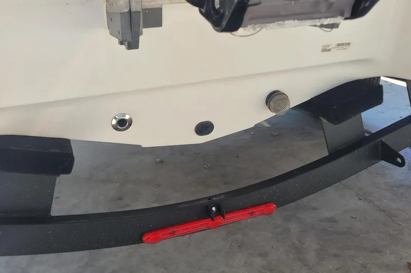 Slide: The Image of Rear view of 2024 Tahoe 200 S boat trailer with red reflector and mounting hardware. - 23