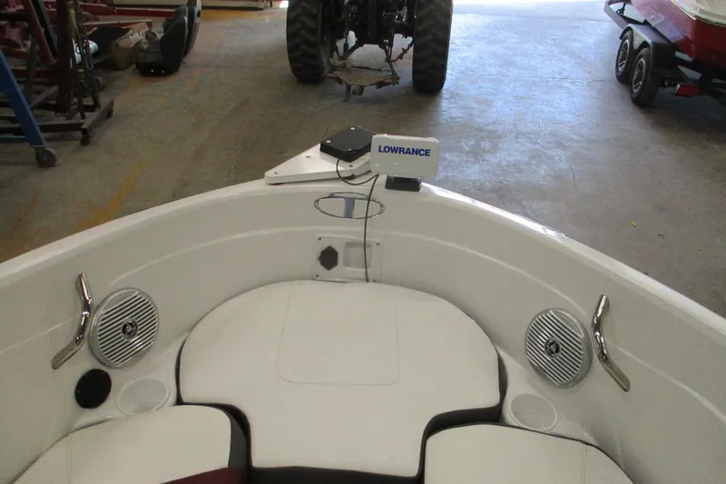Slide: The Image of 2024 Tahoe 200 S boat interior with Lowrance navigation system in a garage setting. - 4