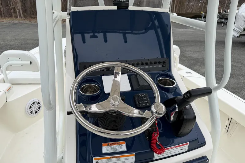 Slide: The Image of 2026 Pathfinder 2200 TRS boat console with steering wheel and controls. - 30