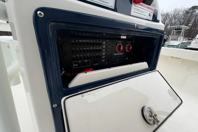 Slide: The Image of 2026 Pathfinder 2200 TRS boat control panel with open access hatch. - 31