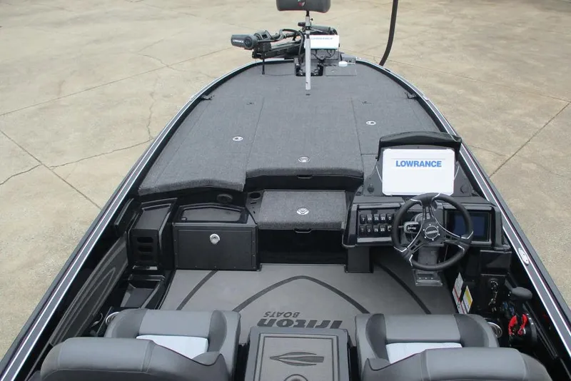 Slide: The Image of 2026 Triton 21XP Patriot boat interior with steering wheel and Lowrance display. - 10