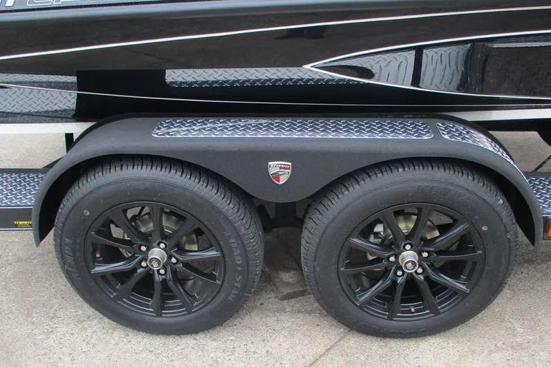 Slide: The Image of 2026 Triton 21XP Patriot trailer with black alloy wheels and diamond plate fenders. - 11