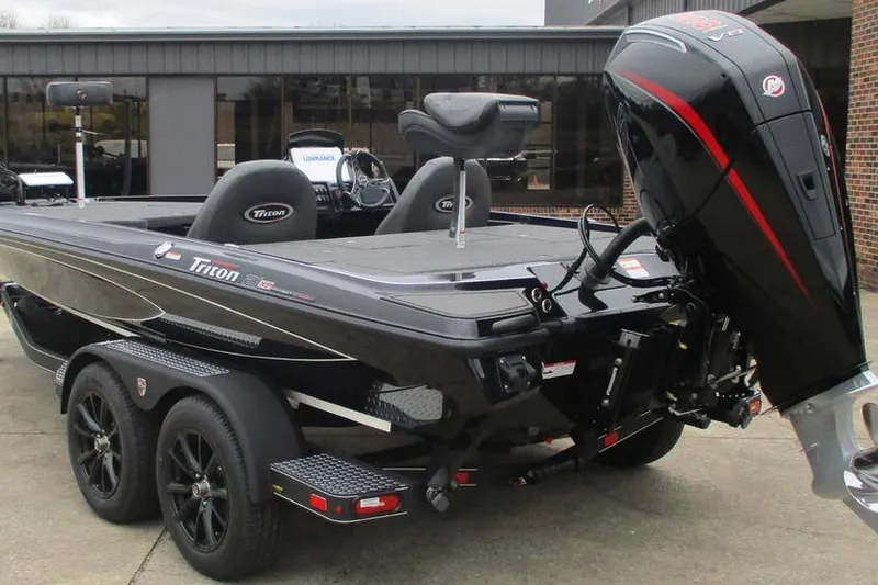 Slide: The Image of 2026 Triton 21XP Patriot boat with dual axle trailer and powerful outboard motor. - 2