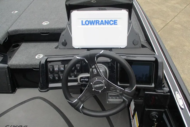 Slide: The Image of 2026 Triton 21XP Patriot boat dashboard with Lowrance display and steering wheel. - 9