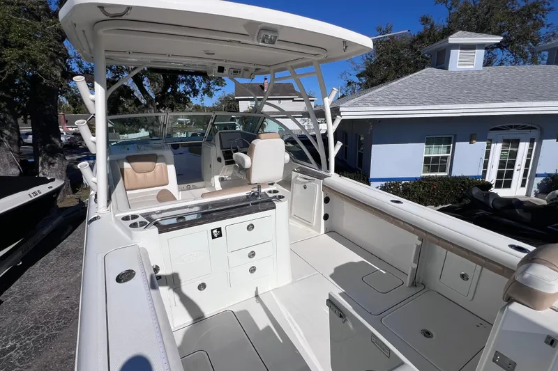 Slide: The Image of 2017 World Cat Glacier Bay Edition 2740 Dual Console boat interior, featuring seating and storage. - 14
