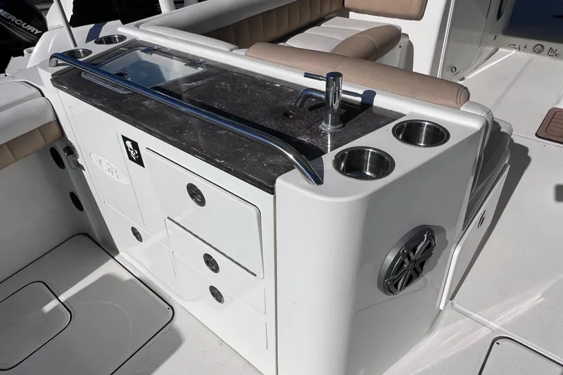 Slide: The Image of 2017 World Cat Glacier Bay Edition 2740 Dual Console boat interior with sink and storage. - 18