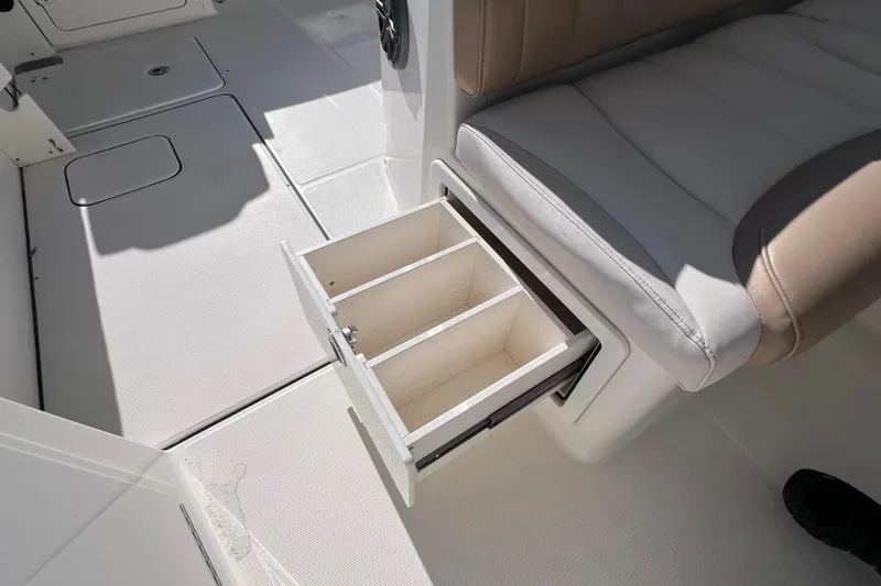 Slide: The Image of 2017 World Cat Glacier Bay Edition 2740 interior with open storage drawer. - 22