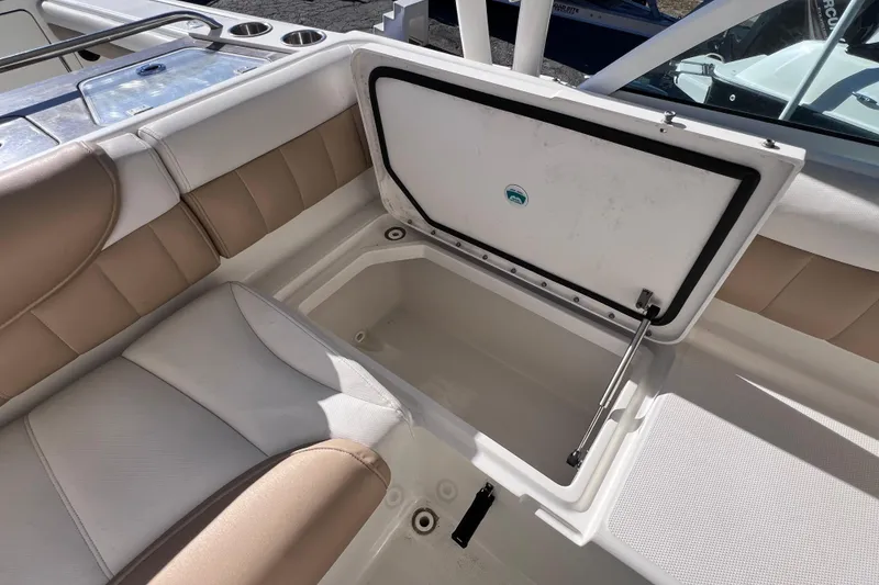 Slide: The Image of 2017 World Cat Glacier Bay Edition 2740 Dual Console boat with open storage compartment. - 24