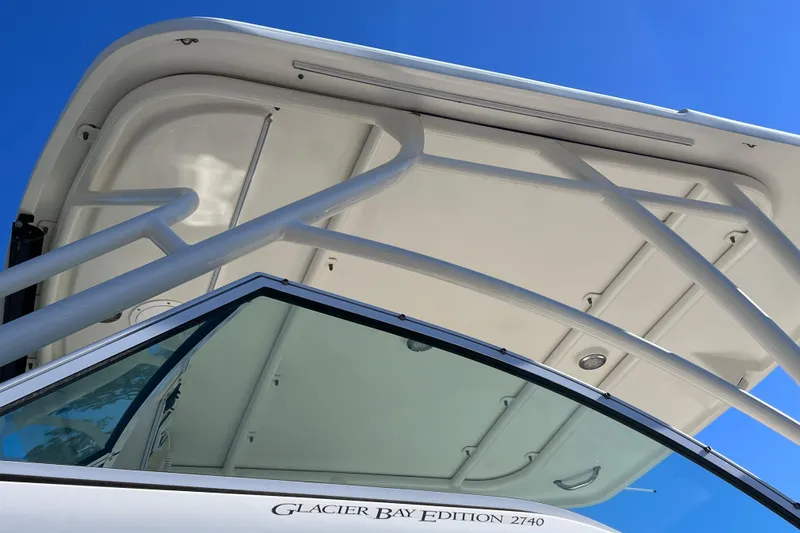 Slide: The Image of 2017 World Cat Glacier Bay Edition 2740 Dual Console boat under clear blue sky. - 5